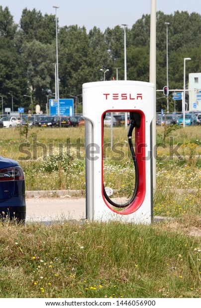 Amsterdam, The\
Netherlands - June 30, 2019: Tesla Super Charging station near\
Schiphol airport in the\
Netherlands