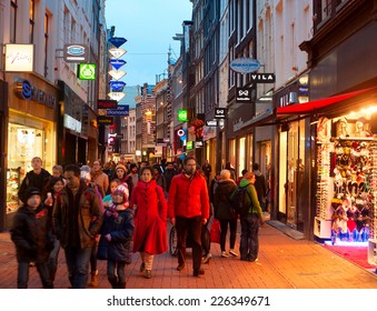 AMSTERDAM, NETHERLANDS - MARCH 01, 2014: Unidentified People Walking On Kalverstraat - Main Shopping Street Of Amsterdam. The Kalverstraat Is The Most Expensive Shopping Street In The Netherlands. 