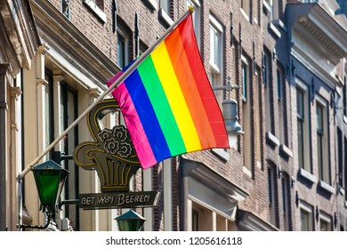 AMSTERDAM, NETHERLANDS - MARCH, 2018: Bet Van Beeren Café 't Mandje And The LGBT Flag At The Old Central District In Amsterdam