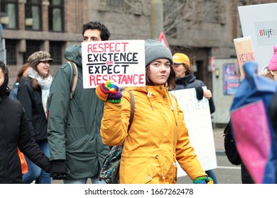 Amsterdam / Netherlands - March 8 2020: Woman marching and holding a sign