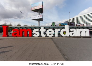 Amsterdam, The Netherlands  - May 1, 2015: View of the red and white I am Amsterdam sign at the arrival/departure entrance of Schiphol international airport.