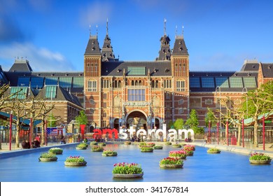 AMSTERDAM, THE NETHERLANDS - MAY 2, 2014: Beautiful tulips in front of the Rijksmuseum (National state museum), a popular touristic destination in Amsterdam, The Netherlands, on May 2, 2014