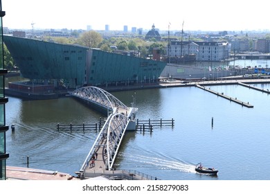 Amsterdam, Netherlands - May 2 2022: Aerial View Of Pedestrian Bridge To Science Museum Nemo And Maritime Museum At River IJ In Amsterdam