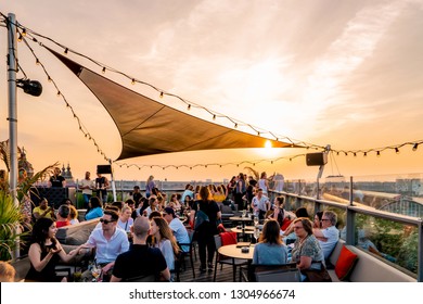 Amsterdam Netherlands May 2018  city skyline during sunset , people on rooftop restaurant bar watching sunset
