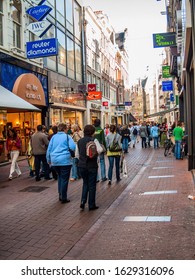 Amsterdam, Netherlands - May 5, 2007: On A Narrow Noisy Street. The Abundance Of Shops, Cafes And Tourists