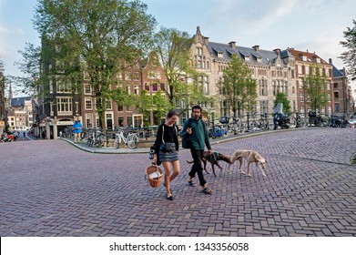 Amsterdam, Netherlands, North Holland - September, 03, 2017: Leliegracht, Amsterdam Canal, People Walking With Dogs