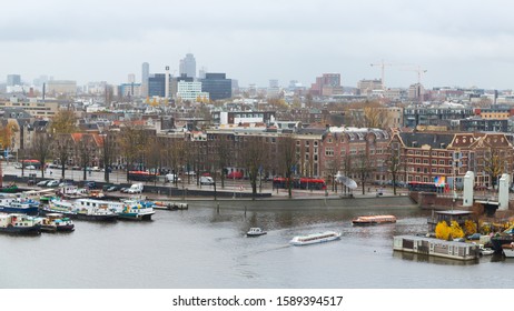 Amsterdam, Netherlands - November 28, 2019: Beatiful landscape view of autumn Amsterdam. Famous vintage buildings and canals of Amsterdam city.