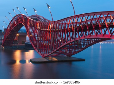 Amsterdam, The Netherlands - October 18, 2013: One Of Two Bridges In The Python Bridge Complex. Example Of Modern Architecture And Design. They Have The Unusual Bent Form And Brightly Red Color .