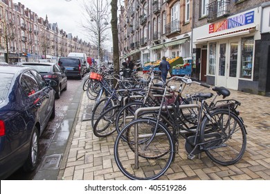 AMSTERDAM, NETHERLANDS on APRIL 1, 2016. Typical urban view in the spring morning. Bicycles are parked on the street.