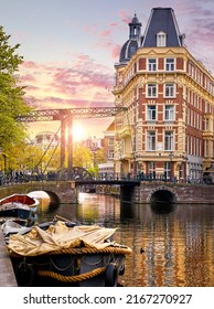 Amsterdam, Netherlands. Panoramic view of autumn Dutch city. Famous channel of Amstel river. Evening cityscape. Colorful sunset scene of famous travel destination in Europe. Romantic traveling place. - Shutterstock ID 2167270927