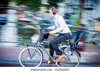 Amsterdam, Netherlands - September 14 2015: Riding A Bike In Amsterdam