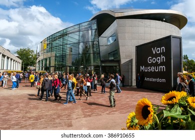 Amsterdam, the Netherlands, September 5, 2015: crowd in front of the new wing of the Van Gogh Museum with sunflowers in the foreground