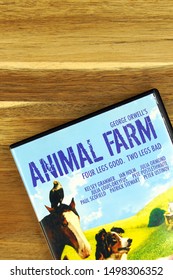 Amsterdam, The Netherlands - September 7, 2019: Part Of A DVD Movie Cover From George Orwell's Animal Farm Against A Wooden Background.