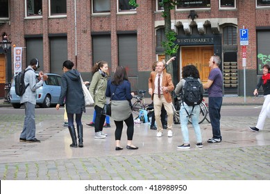 AMSTERDAM, NETHERLANDS___CIRCA MAY 31, 2014___Co Workers Having A Block Dance Party On The Street Of Amsterdam After Work.