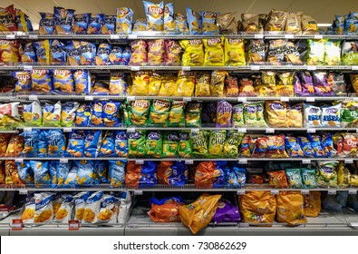 Amsterdam, October 2017. Large Assortment Of Potato Chips And Other Salty Snacks In A Supermarket