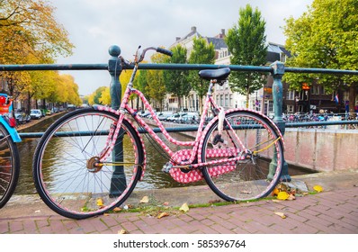 AMSTERDAM - OCTOBER 27: Bicycle parked at the bridge on October 27, 2016 in Amsterdam, Netherlands.