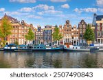 Amsterdam. Panoramic view of the historic city center of Amsterdam. Traditional houses and bridges of Amsterdam. An early quiet morning  . Europe, Netherlands, Holland, Amsterdam.