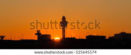 Amsterdam Schiphol airport skyline at sunset, panoramic view.
