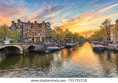 Amsterdam sunset city skyline at canal waterfront, Amsterdam, Netherlands