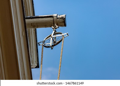 Amsterdam traditional houses, Pretty Dutch style gable roof tops under blue sky with pulley and rope, Lifting beam and wheel for transporting items into or out of a tall house, Netherlands. 