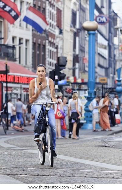 AMSTERDAM-AUG. 19. Cycling girl. In A\'dam 38% of\
traffic movement in the city is by bike , 37% by car, 25% public\
transport. In the center, 57% of traffic movement by bike.\
Amsterdam, Aug. 19,\
2012