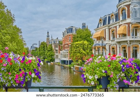 Amsterdam,Holland, flowers and traditional houses on a canal