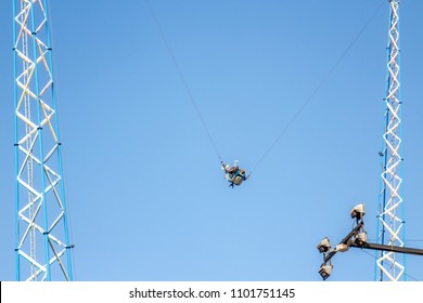 Amusement Park Ride, People Hanging In Slingshot