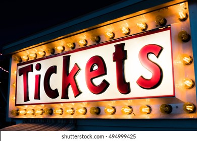 Amusement Park Ride Ticket Booth Sign At Night With Lights