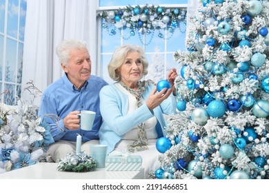 Amusing couple at home decorating Christmas tree - Powered by Shutterstock