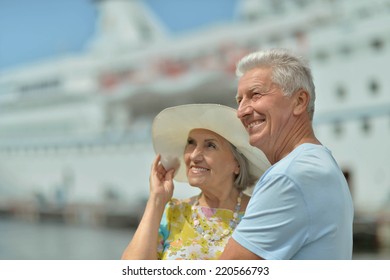 Amusing elderly couple against the background of the ship - Powered by Shutterstock