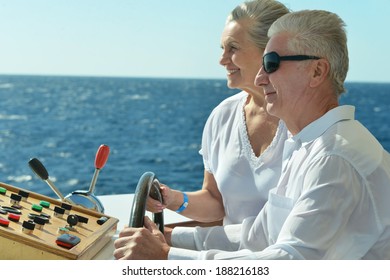 Amusing Elderly Couple Have A Ride In A Boat On Sea