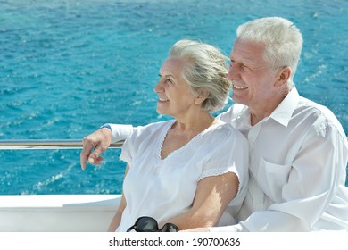 Amusing Elderly Couple Have A Ride In A Boat On Sea