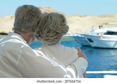 Amusing Elderly Couple Have A Ride In A Boat On Sea