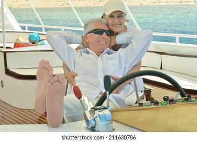 Amusing Elderly Couple Have A Ride In A Boat On Sea