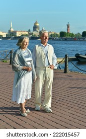 Amusing elderly couple having rest near river