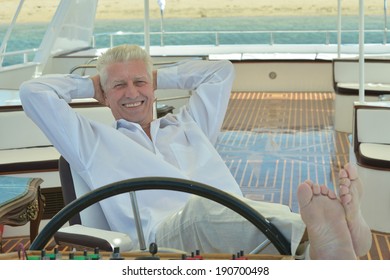 Amusing elderly man have a ride in a boat on sea - Powered by Shutterstock