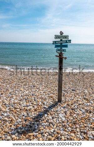 amusing sign on the beach caution mermaid swimming area