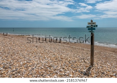 amusing sign on the beach caution mermaid swimming area	