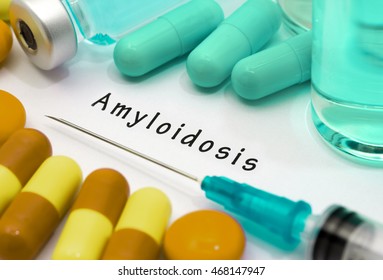 Amyloidosis - diagnosis written on a white piece of paper. Syringe and vaccine with drugs.