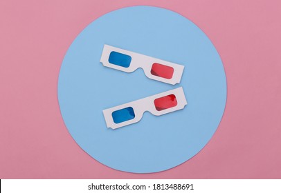 Anaglyph 3D Glasses On Pink Background With A Blue Circle. Conceptual Studio Shot. Minimalism. Top View