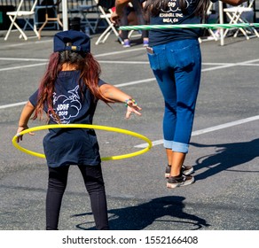 Anaheim, CA / USA - Nov 3, 2019: Cute Little Girl And A Woman Playing With Colorful Hula Hoops At The 2019 JDRF One Walk Fundraiser.