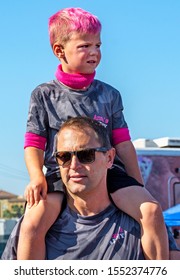 Anaheim, CA / USA - Nov 3, 2019: Close Up Of A Cute, Young Boy With Dyed Pink Hair Sitting On His Father's Shoulders At The 2019 JDRF One Walk Fundraiser. Walk To Raise Funds For Type 1 Diabetes Cure.