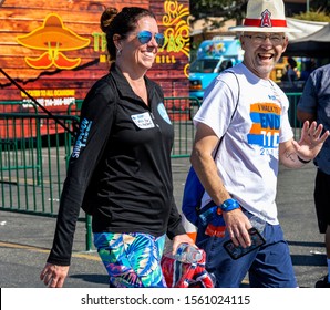 Anaheim, CA / USA - Nov 3, 2019: Happy Couple Walks Across Finish Line At The JDRF One Walk Fundraiser For Type 1 Diabetes At Angel Stadium. The Man Is Laughing And Waving And The Woman Is Smiling.