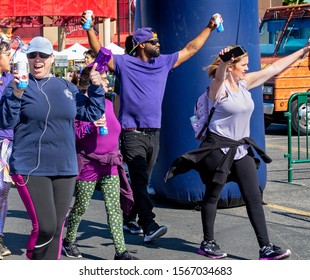 Anaheim, CA / USA - Nov 3, 2019: Young Black Man And Friends Raise Their Hands In The Air In Victory As They Cross The Finish Line At The 2019 JDRF One Walk To Support Research For Type 1 Diabetes.