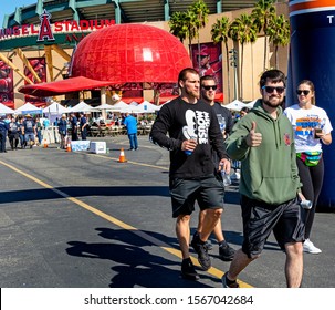 Anaheim, CA / USA - Nov 3, 2019: An Attractive Young Man Dressed In Green Flashes A Thumbs Up As He Crosses The Finish Line With His Friends At The 2019 JDRF One Walk To Support Diabetes Research.