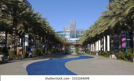 Anaheim, CA  USA - September 22, 2019: Long Shot Of The Anaheim Convention Center Framed By Palms, With A Blue Walkway Leading To The Lobby