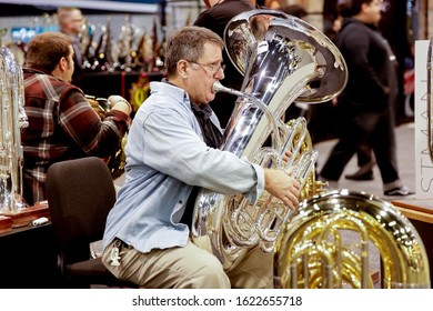 Anaheim, California, United States - 01-19-2020: A Man Tests Out A New Eastman Tuba At The Eastman Booth At The NAMM Show.