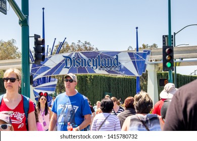 Anaheim, California/United States - 04/24/2019: Tourist Walk Across The Street Towards Disneyland Theme Park