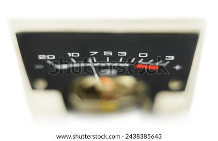 Analog arrow signal meter in decibel with black skale. Wiev from top. Selective focus. Isolated on white background 