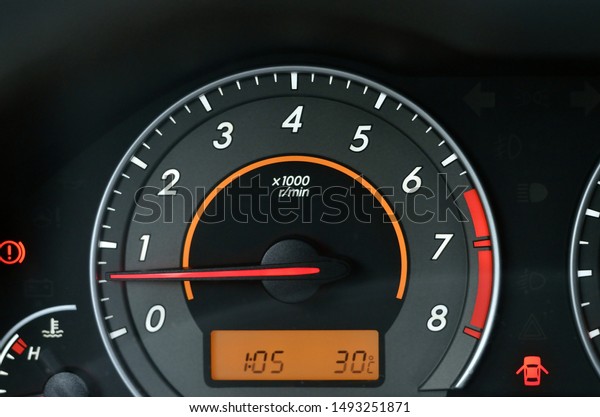 Analog\
backlit tachometer of automotive vehicle\
dashboard